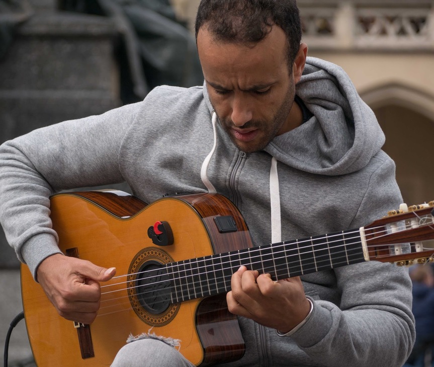 guitarist playing on the sidewalk